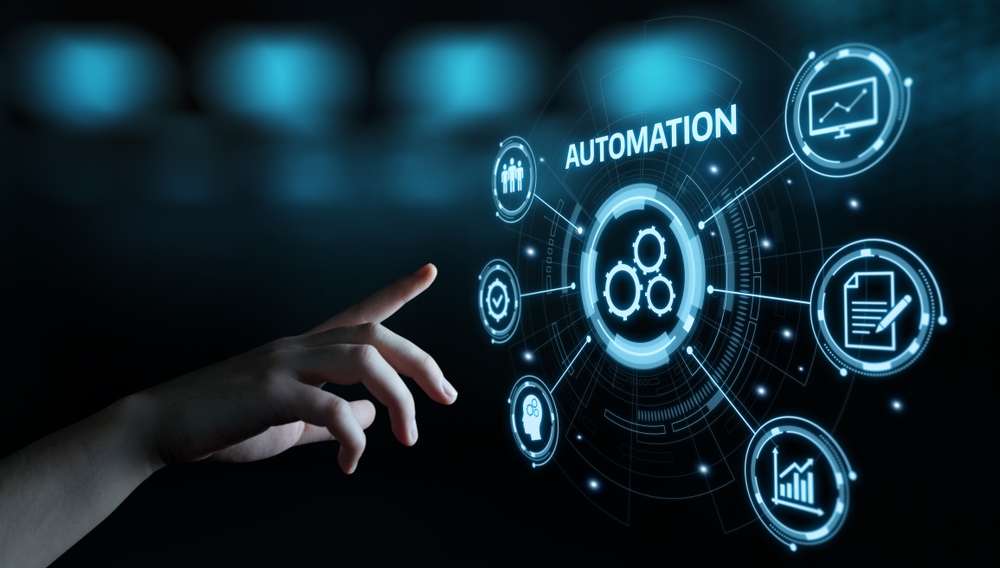 Hand pointing at a glowing cyan automation hub of gears and circular icons