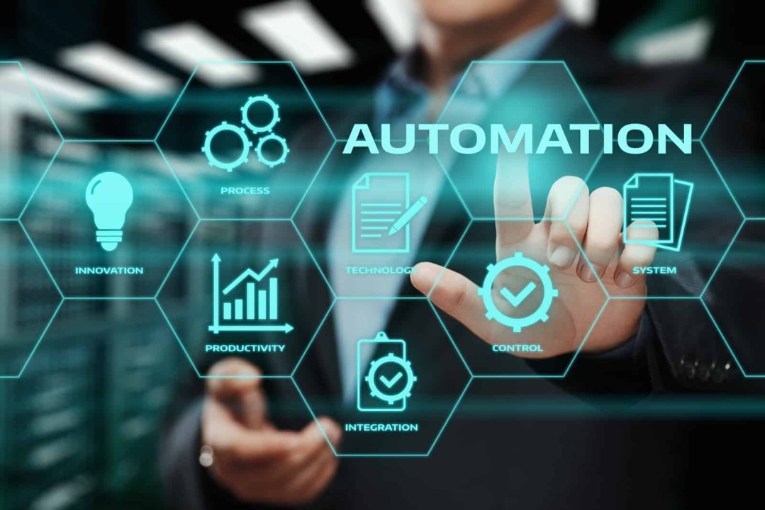 Businessman touching a glowing teal hexagon grid labelled Process, Innovation, Technology, System, Productivity, Control and Integration around the word Automation